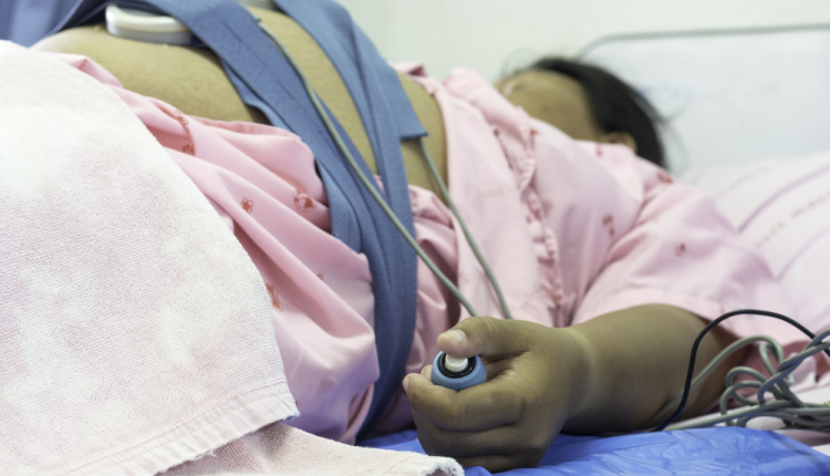 A pregnant woman on a hospital bed
