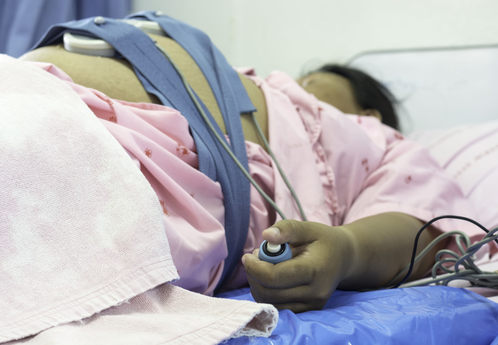 A pregnant woman on a hospital bed