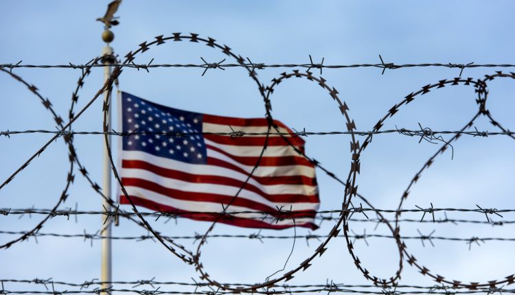 American flag at the border with barbed wire