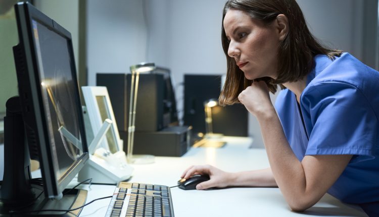 An NHS employee using a computer