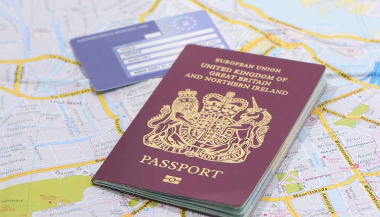 United Kingdom passport and EU health card on a road map
