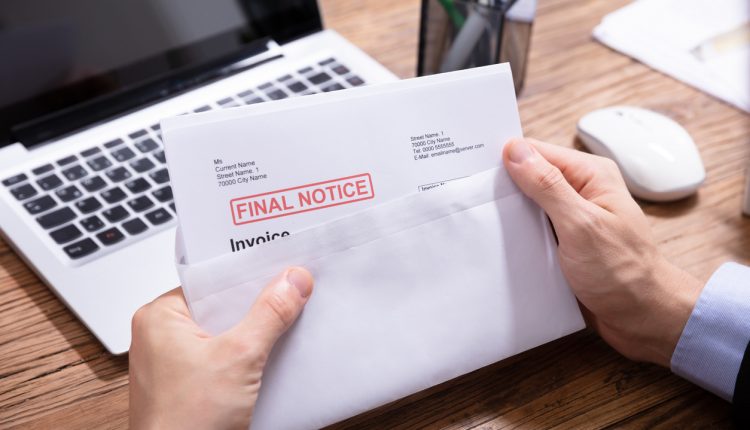 Man holding final notice invoice