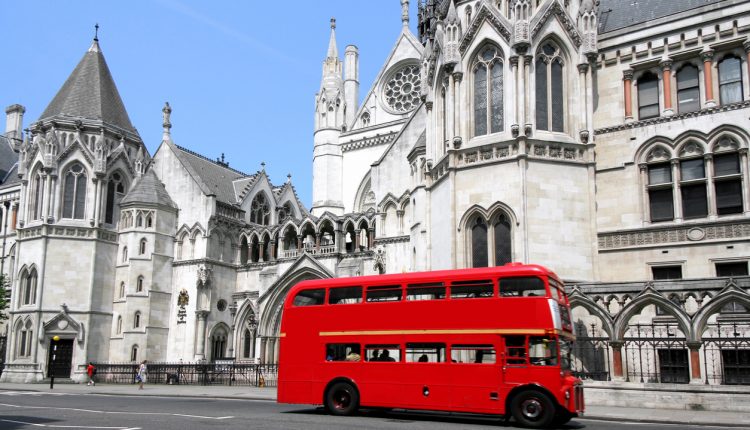 Red London bus outside the Royal Courts of Justice