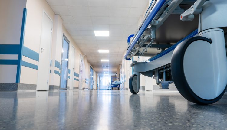 Wheeled medical bed in a hospital corridor