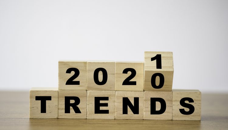 flipping 2020 to 2021 trends print screen on wooden block cubes. New idea business fashion popular and relevant topics.