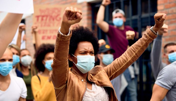 Black female activist wearing a face mask