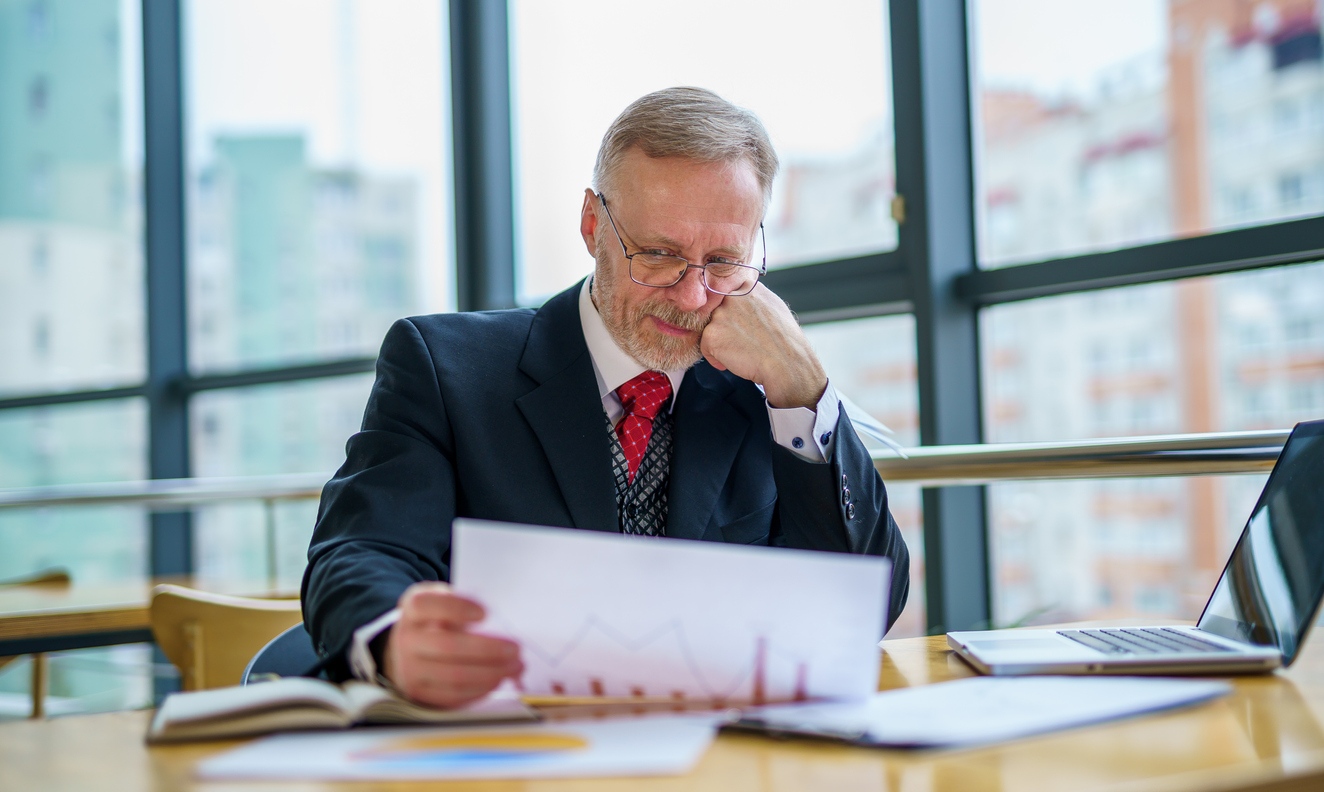 Middle-aged lawyer reviewing data in a modern office