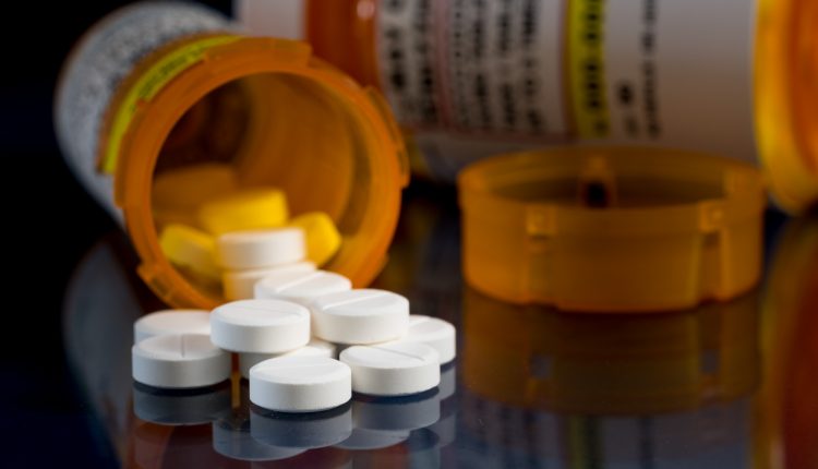 Oxycodone opioid tablets in prescription bottles