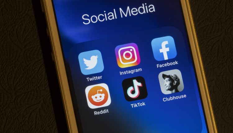 Smartphone displaying Twitter, Instagram, Facebook, Reddit, TikTok and Clubhouse apps