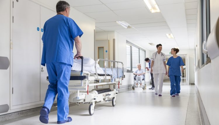 Nurse pushing a gurney in a hospital corridor