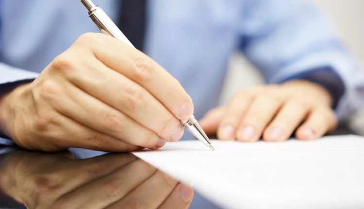 Businessman signing a will
