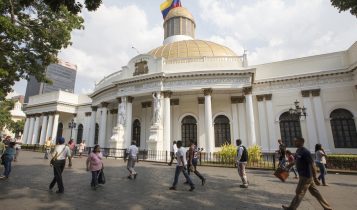People walking in front of National Assembling Capitolio Congress, Venezuela