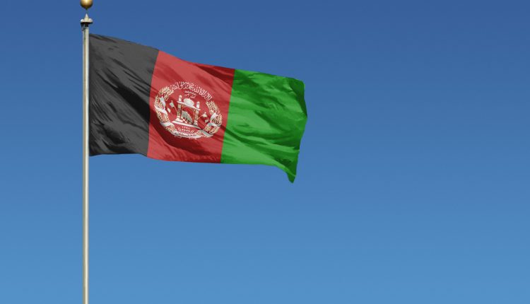 National flag of Afghanistan on clear blue sky