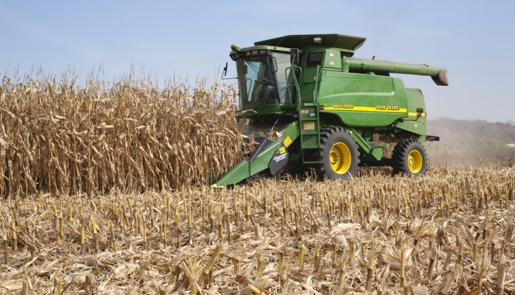 Deere combine harvests corn