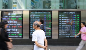 Hong Kong: people look for the hang seng stock index in Mong kok