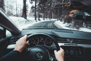 Driving car down snowy road