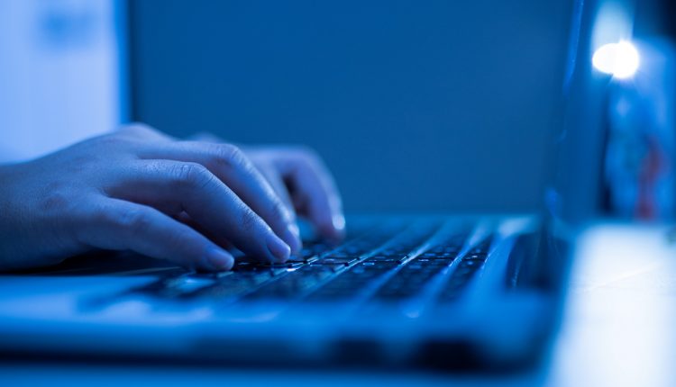 Man using laptop; phishing scam