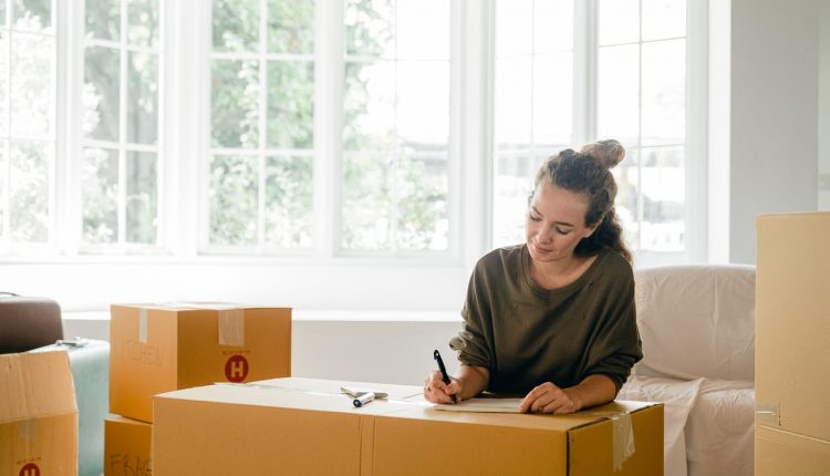 Woman packing boxes, ready to move abroad