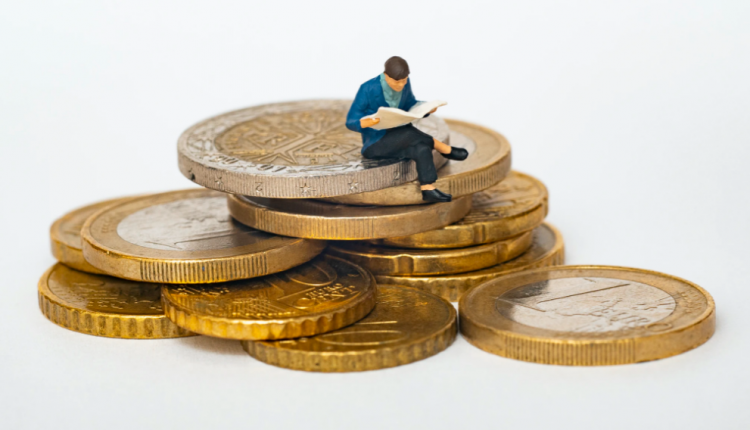 Figure sat on stack on coins representing legal marketing budget