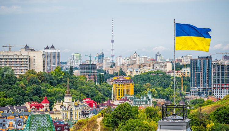 Kyiv, Ukraine cityscape of Kiev and Ukrainian flag