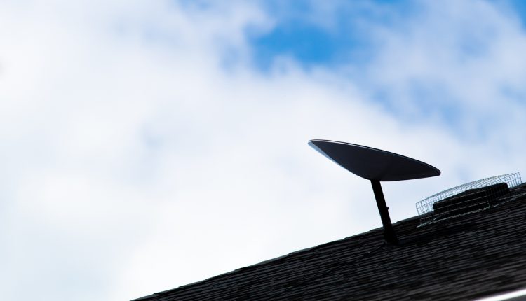 A SpaceX Starlink satellite dish is seen installed on a roof of a home