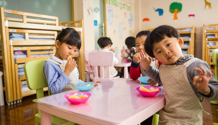 Children sat at table in daycare