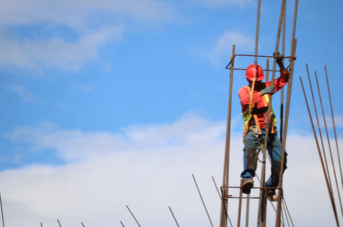 Worker climbing scaffolding