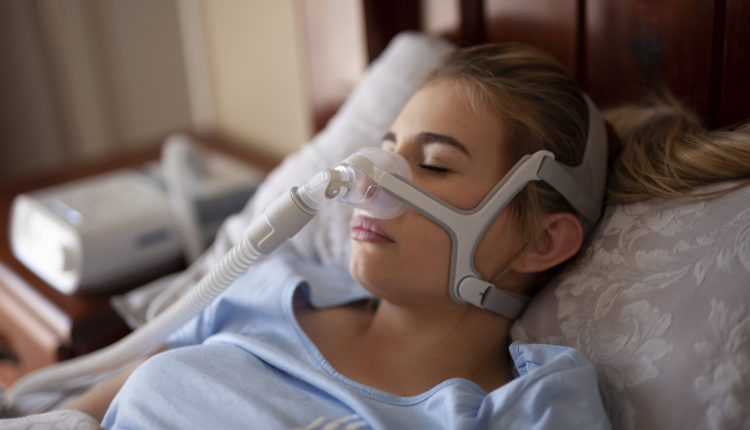 Woman using CPAP machine