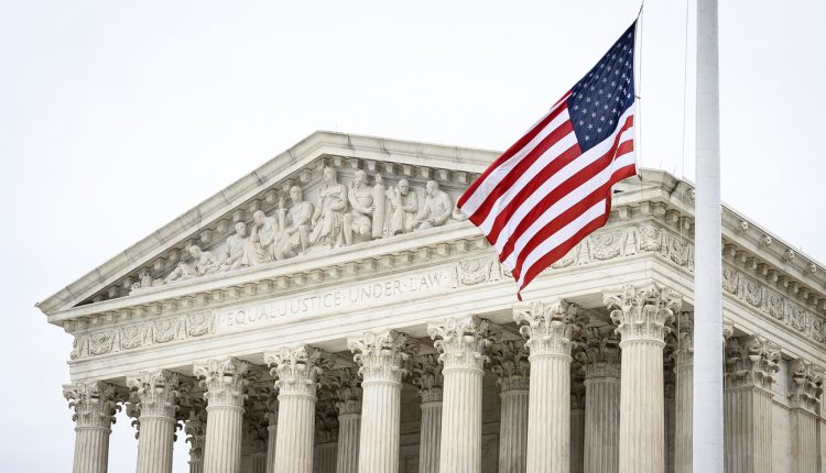 A picture of the supreme court, with the US flag waving in front of the phrase "Equal Justice Under Law"