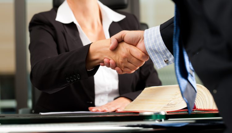 Female lawyer shaking hands with colleague