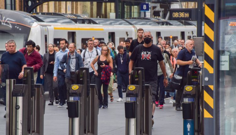 Commuters on a London train platform.