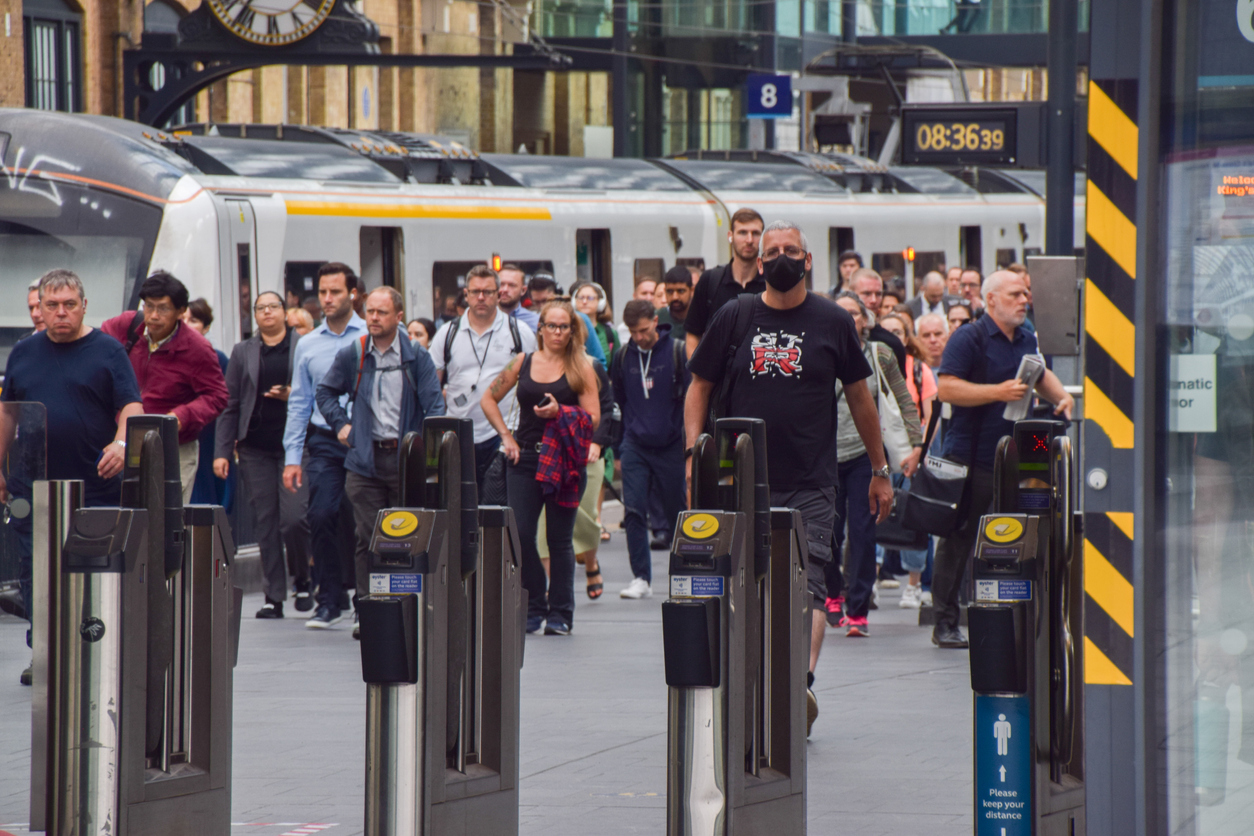Commuters on a London train platform.
