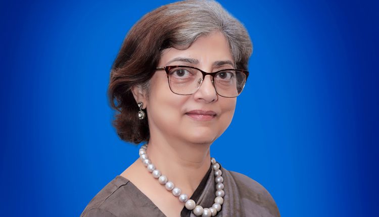 Prominent patent attorney Anju Khanna stands in front of a blue background.