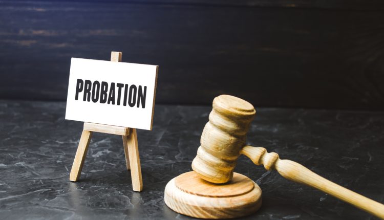 Probation and judge's gavel. Consideration of an application for early release from imprisonment. Protection of workers rights. Test period. Performance and efficiency testing.