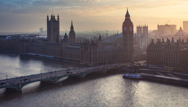 Houses of parliament and Thames river at sunset.