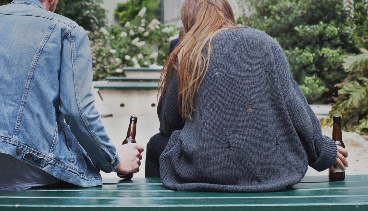 alcoholism concept, young people drinking beer on the street