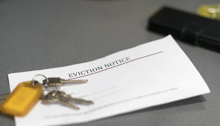 House keys sitting on an eviction notice received in the mail.