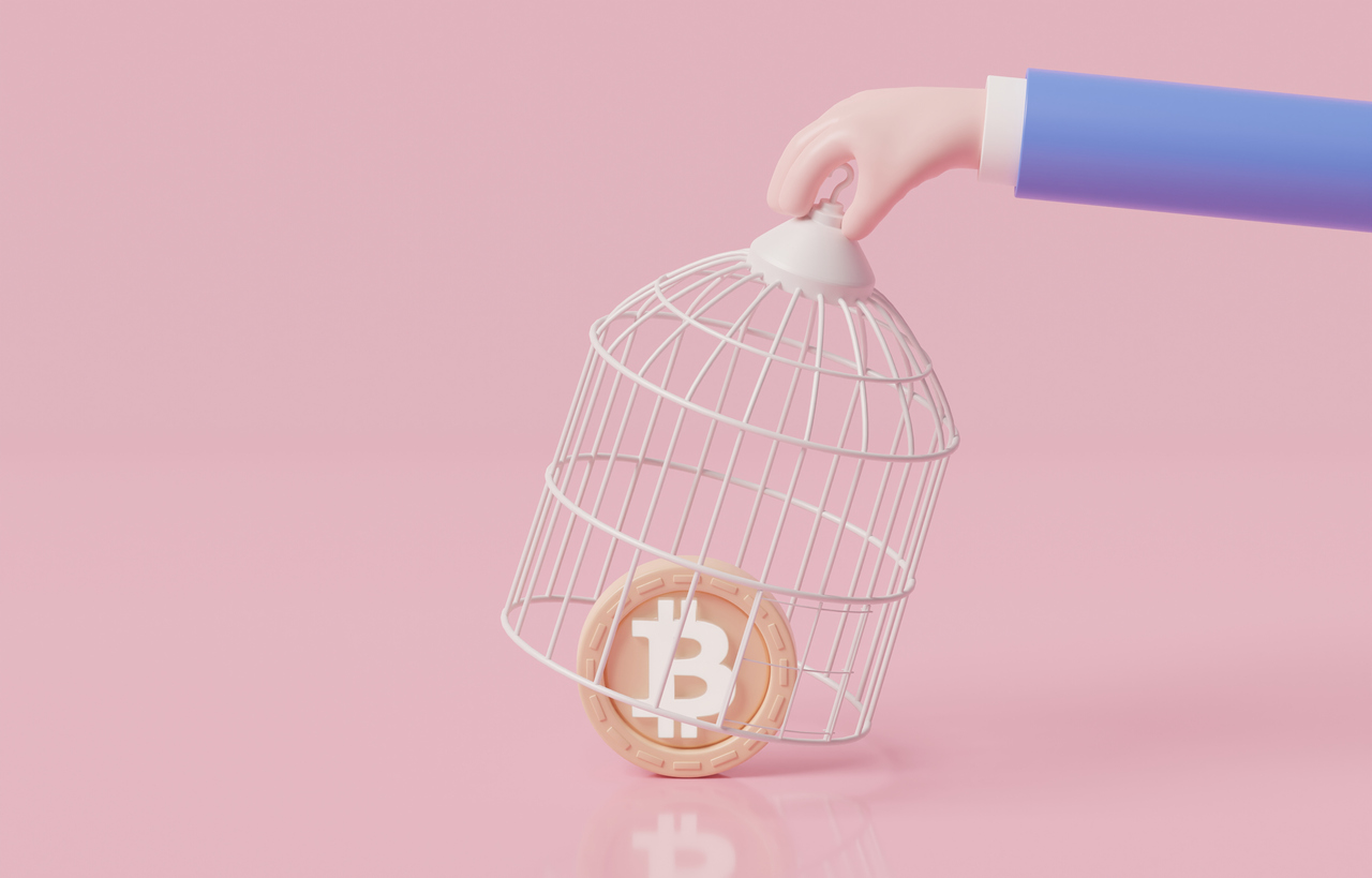 Hand catching bitcoin with birdcage, government try to regulate bitcoin and cryptocurrency, policy for collecting taxes on crypto trading concept.