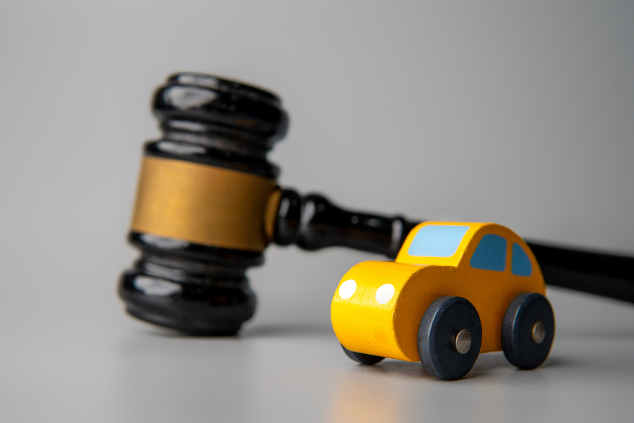 a gavel and a toy car.