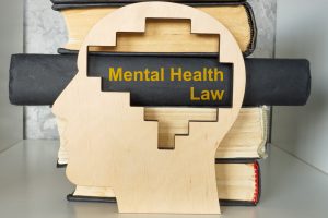 book titled mental health law and a head model.
