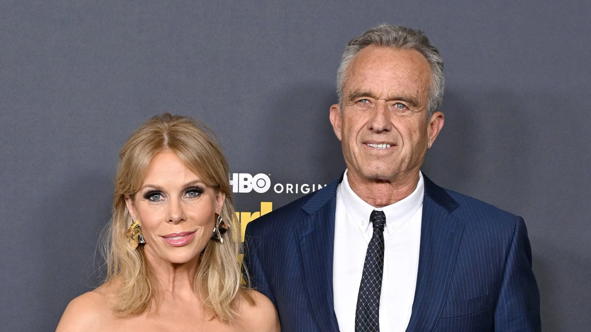 Cheryl Hines and Robert F. Kennedy Jr. attend an event together, both smiling and dressed in formal attire.
