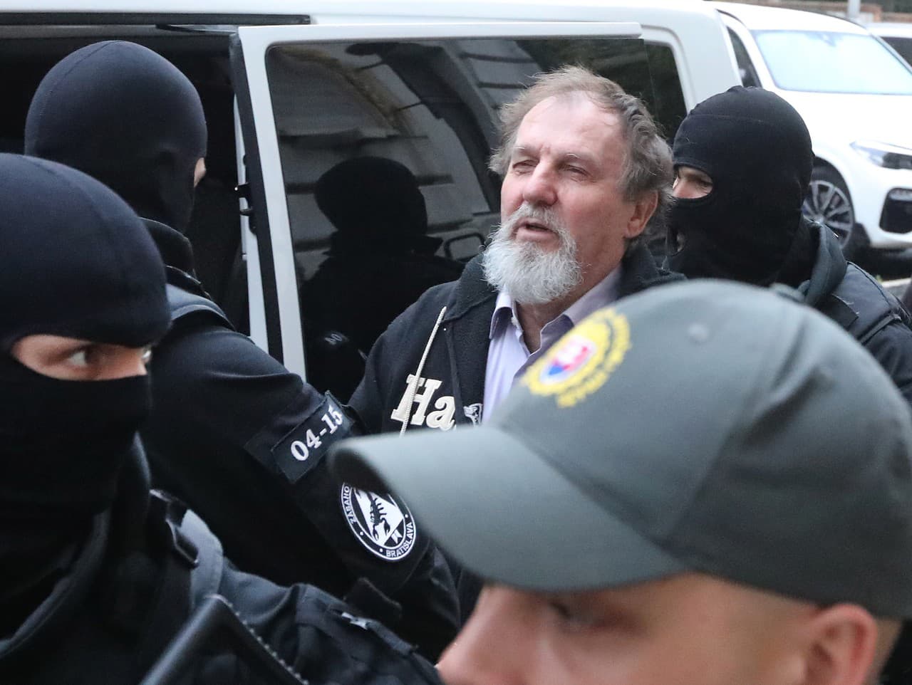 Juraj Cintula escorted by armed police officers after being found guilty of a terrorist attack on Slovak Prime Minister Robert Fico.