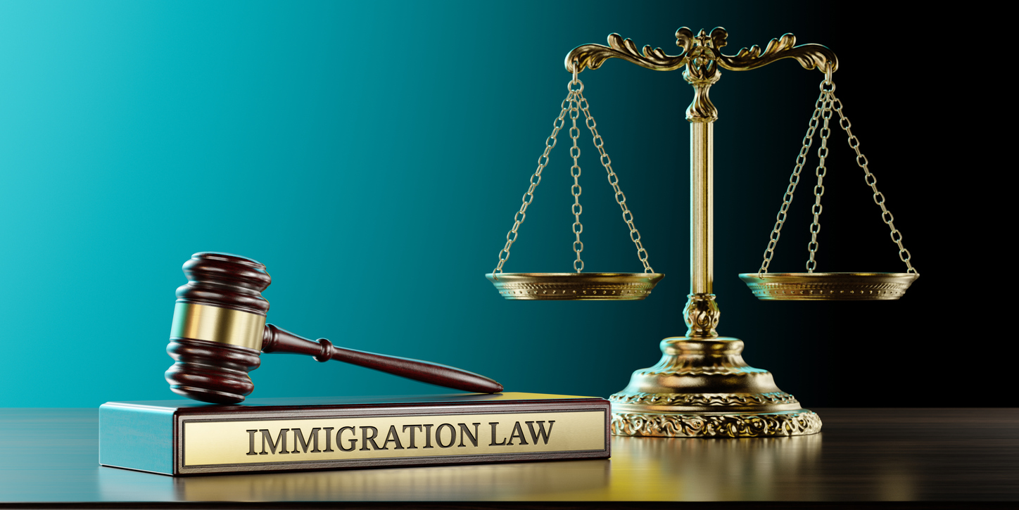 immigration law: judge's gavel as a symbol of legal system, scales of justice and wooden stand with text word