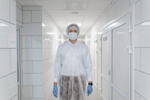 a doctor in proctective clothing to prevent the spread of chemicals.