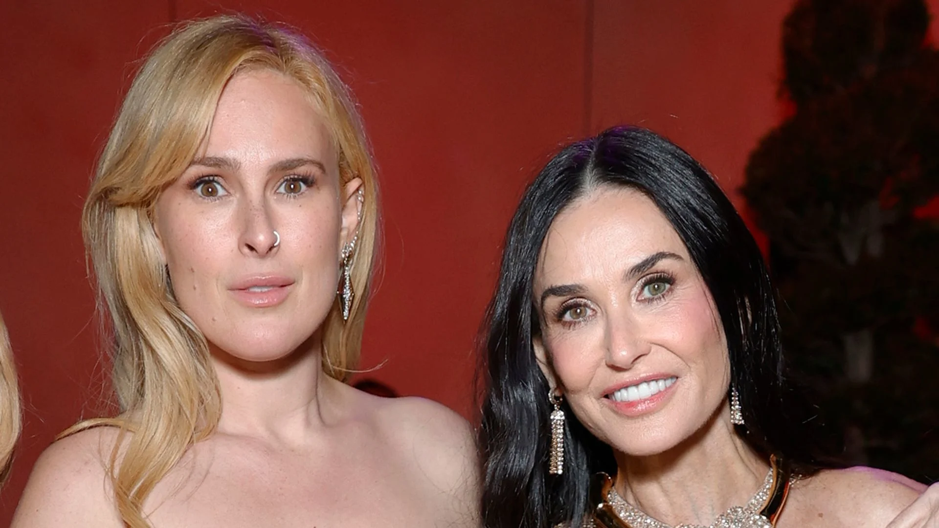 Headshot of actress Demi Moore smiling next to her daughter Rumer Willis, who has blonde hair and a nose ring.