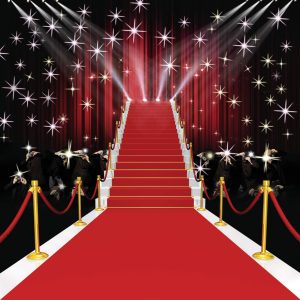 Red carpet staircase with velvet ropes and photographers in a staged event setting