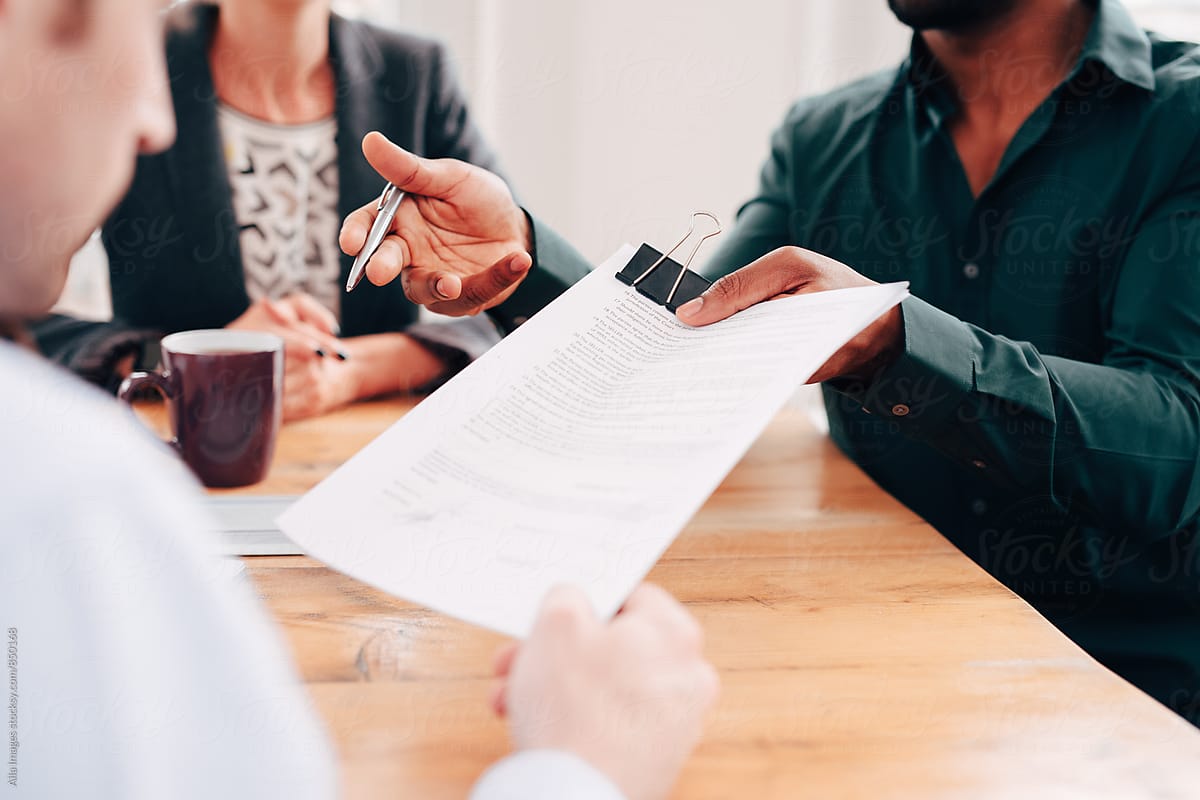 Couple reviewing legal documents with a professional during a discussion about family agreements and long-term planning.