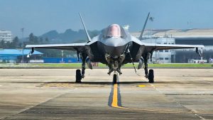 An F-35 fighter jet on the runway during ground preparations, photographed head-on at an air base