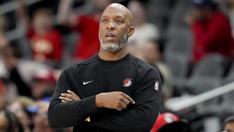 Chauncey Billups standing courtside during a Portland Trail Blazers game.