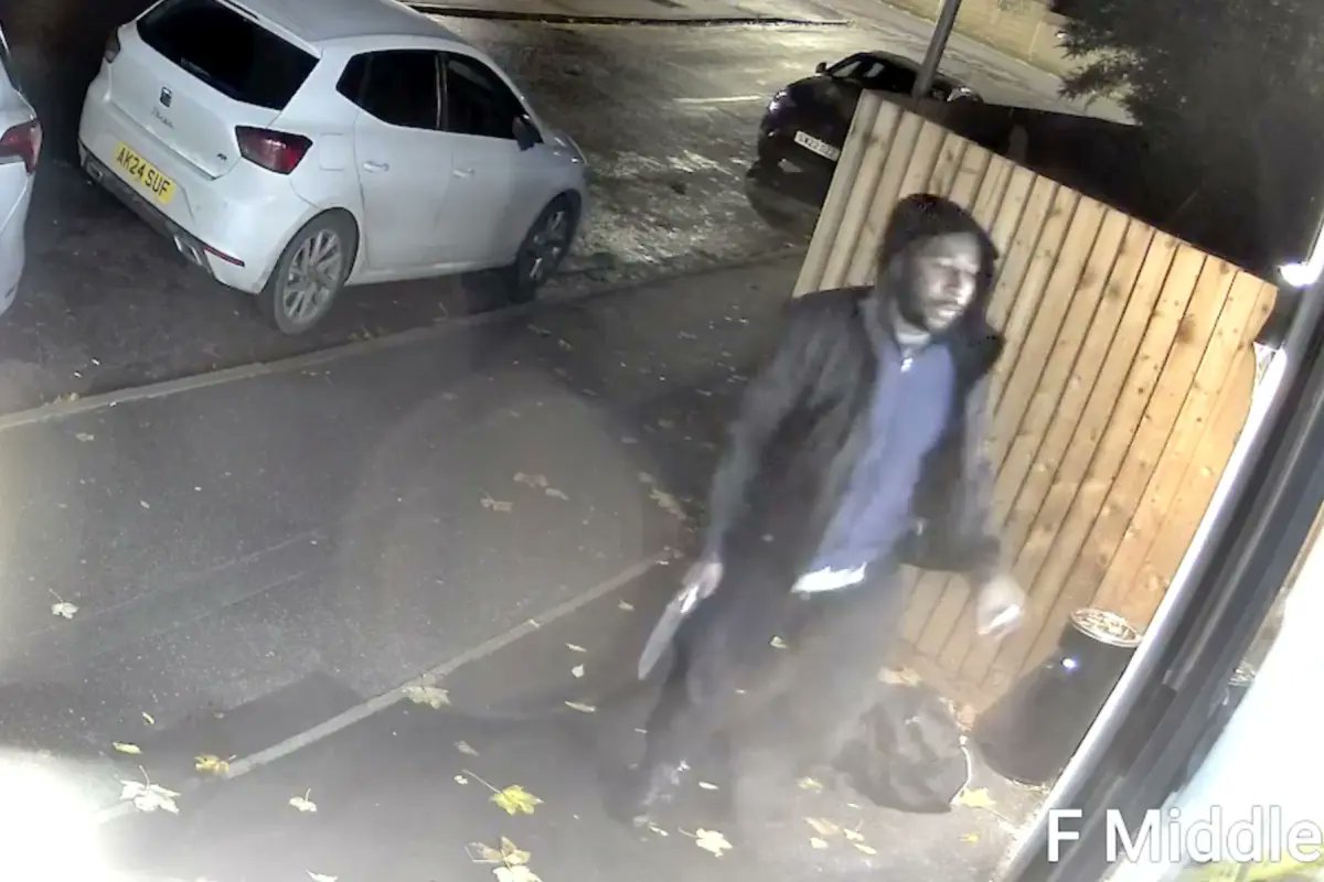 Anthony Williams seen holding a knife near a barbershop entrance in Peterborough shortly before the Huntingdon train stabbings, November 1, 2025.